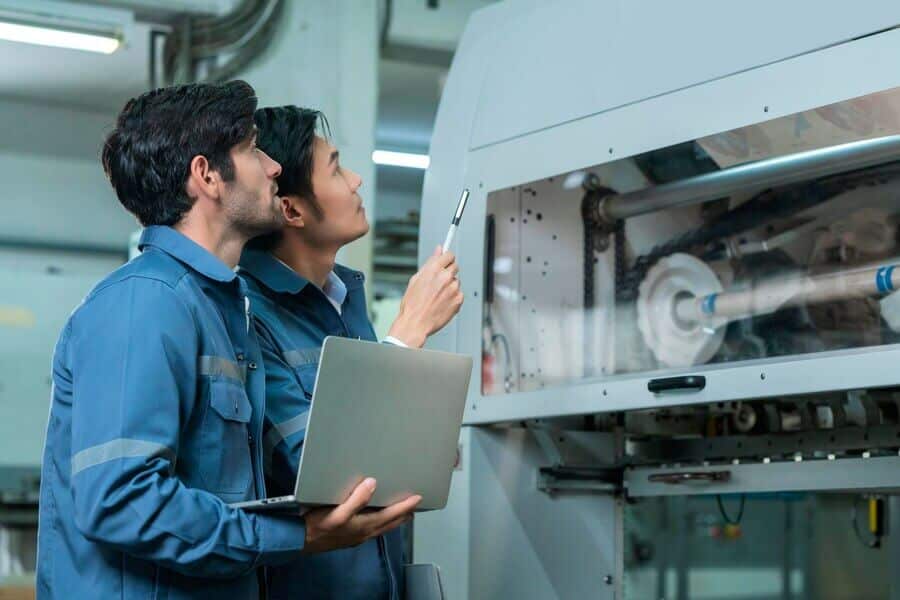 male asian caucasian engineer professional having discussion standing consult machine factory two expert coworker brainstorm explaining solves process cnc operate machine 609648 683 1