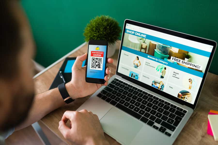young man using discount coupon his smartphone some online shopping laptop 662251 2177 1
